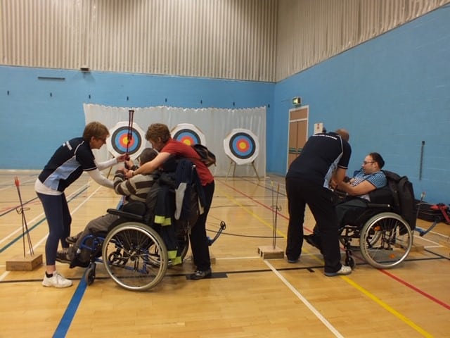 wheelchair archers and coaches