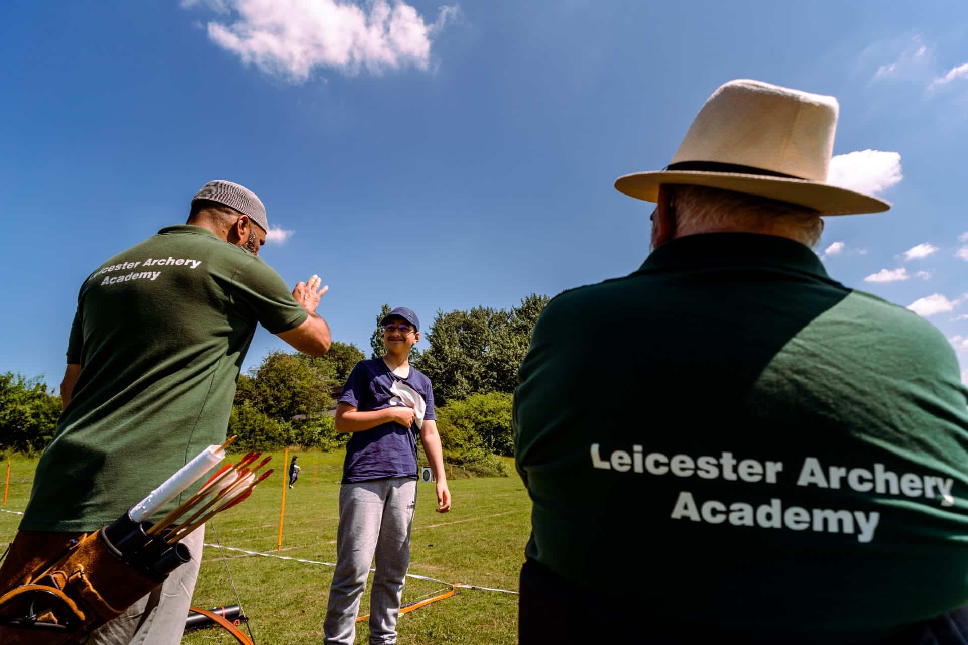 Coaches helping a beginner at Leicester Archery Academy